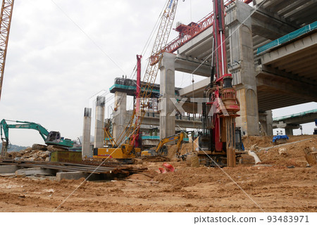 SELANGOR, MALAYSIA -JUNE 30, 2022: Bore pile rig machine at the construction site. The machine used to driven pile for building foundation work. Operated by skilled workers. Heavy machinery. SELANGOR, MALAYSIA -JUNE 30, 2022: Bore pile rig machine at the construction site. The machine used to driven pile for building foundation work. Operated by skilled workers. Heavy machinery. 93483971