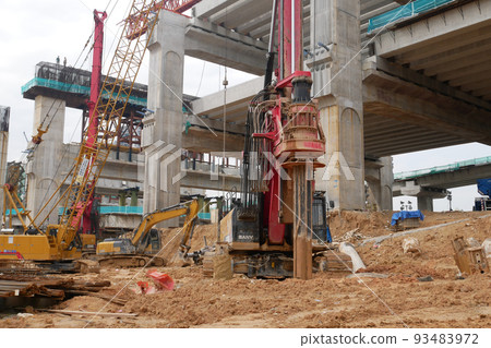 SELANGOR, MALAYSIA -JUNE 30, 2022: Bore pile rig machine at the construction site. The machine used to driven pile for building foundation work. Operated by skilled workers. Heavy machinery. SELANGOR, MALAYSIA -JUNE 30, 2022: Bore pile rig machine at the construction site. The machine used to driven pile for building foundation work. Operated by skilled workers. Heavy machinery. 93483972