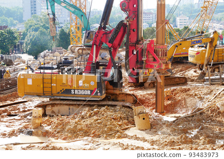 SELANGOR, MALAYSIA -JUNE 30, 2022: Bore pile rig machine at the construction site. The machine used to driven pile for building foundation work. Operated by skilled workers. Heavy machinery. SELANGOR, MALAYSIA -JUNE 30, 2022: Bore pile rig machine at the construction site. The machine used to driven pile for building foundation work. Operated by skilled workers. Heavy machinery. 93483973