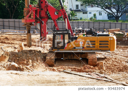 SELANGOR, MALAYSIA -JUNE 30, 2022: Bore pile rig machine at the construction site. The machine used to driven pile for building foundation work. Operated by skilled workers. Heavy machinery. SELANGOR, MALAYSIA -JUNE 30, 2022: Bore pile rig machine at the construction site. The machine used to driven pile for building foundation work. Operated by skilled workers. Heavy machinery. 93483974