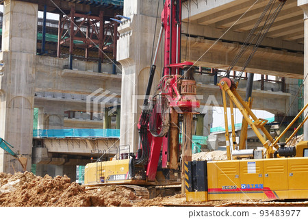 SELANGOR, MALAYSIA -JUNE 30, 2022: Bore pile rig machine at the construction site. The machine used to driven pile for building foundation work. Operated by skilled workers. Heavy machinery. SELANGOR, MALAYSIA -JUNE 30, 2022: Bore pile rig machine at the construction site. The machine used to driven pile for building foundation work. Operated by skilled workers. Heavy machinery. 93483977