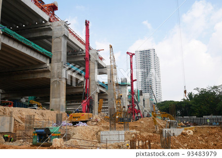 SELANGOR, MALAYSIA -JUNE 30, 2022: Bore pile rig machine at the construction site. The machine used to driven pile for building foundation work. Operated by skilled workers. Heavy machinery. SELANGOR, MALAYSIA -JUNE 30, 2022: Bore pile rig machine at the construction site. The machine used to driven pile for building foundation work. Operated by skilled workers. Heavy machinery. 93483979