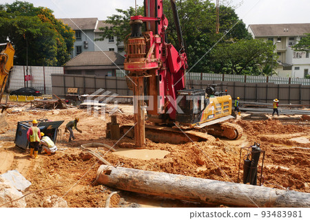 SELANGOR, MALAYSIA -JUNE 30, 2022: Bore pile rig machine at the construction site. The machine used to driven pile for building foundation work. Operated by skilled workers. Heavy machinery. SELANGOR, MALAYSIA -JUNE 30, 2022: Bore pile rig machine at the construction site. The machine used to driven pile for building foundation work. Operated by skilled workers. Heavy machinery. 93483981