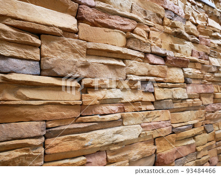 Artificial stone cladding. Designed to resemble real stone. Arranged vertically and attached to the wall with a special adhesive. Used as decoration on the walls of buildings. Artificial stone cladding. Designed to resemble real stone. Arranged vertically and attached to the wall with a special adhesive. Used as decoration on the walls of buildings. 93484466