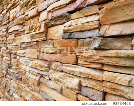 Artificial stone cladding. Designed to resemble real stone. Arranged vertically and attached to the wall with a special adhesive. Used as decoration on the walls of buildings. Artificial stone cladding. Designed to resemble real stone. Arranged vertically and attached to the wall with a special adhesive. Used as decoration on the walls of buildings. 93484468