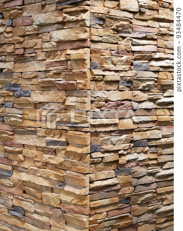 Artificial stone cladding. Designed to resemble real stone. Arranged vertically and attached to the wall with a special adhesive. Used as decoration on the walls of buildings. Artificial stone cladding. Designed to resemble real stone. Arranged vertically and attached to the wall with a special adhesive. Used as decoration on the walls of buildings. 93484470