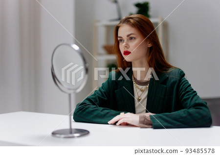 A tired young business lady came after work and thinks looking away about solving a difficult issue, resolving the crisis A tired young business lady came after work and thinks looking away about solving a difficult issue, resolving the crisis 93485578