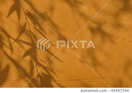 Shadow of leaves on brown concrete wall texture background Shadow of leaves on brown concrete wall texture background 93487104