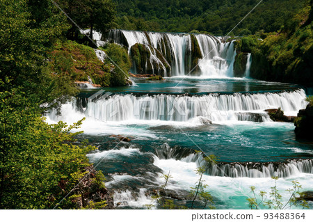 a magnificent waterfall called strbacki buk on the beautifully clean and drinking Una river in Bosnia and Herzegovina in the middle of a forest. a magnificent waterfall called strbacki buk on the beautifully clean and drinking Una river in Bosnia and Herzegovina in the middle of a forest. 93488364