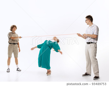 Group of young people, men and woman in 70s, 80s fashion style clothes playing isolated on white background. Vintage, retro style concept Group of young people, men and woman in 70s, 80s fashion style clothes playing isolated on white background. Vintage, retro style concept 93489753