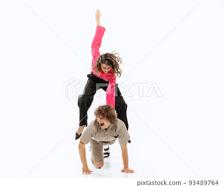 Young man and woman in 50s, 60s fashion style clothes having fun isolated on white background. Retro vintage style, business, ad, emotions 93489764