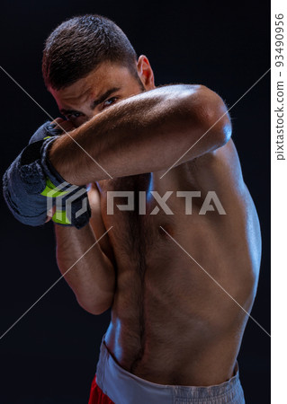 Double arm block. Boxing trainer showing defensive techniques. Combat sport, fight club. 93490956