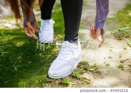 Woman's hand tying shoe laces 93491818