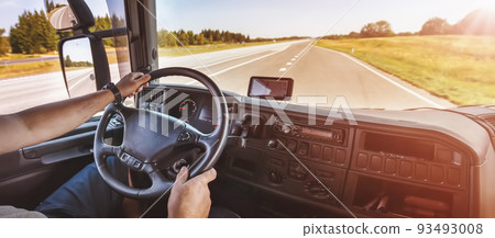 Driver of semi-truck sitting and drining his vehicle 93493008