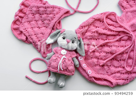 Beautiful baby knitted clothes and a toy for a newborn baby Beautiful baby knitted clothes and a toy for a newborn baby 93494259