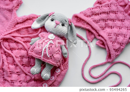 Beautiful baby knitted clothes and a toy for a newborn baby Beautiful baby knitted clothes and a toy for a newborn baby 93494265