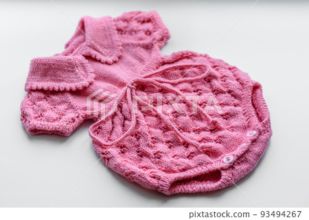Beautiful baby knitted clothes and a toy for a newborn baby Beautiful baby knitted clothes and a toy for a newborn baby 93494267