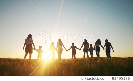 community large family in the park. a large group of people holding hands walking silhouette on nature sunset in the park. big family kid dream concept. people in lifestyle the park. large family community large family in the park. a large group of people holding hands walking silhouette on nature sunset in the park. big family kid dream concept. people in lifestyle the park. large family 93495126