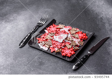 Christmas decorations and gingerbreads on a dark concrete table. Getting ready to celebration Christmas decorations and gingerbreads on a dark concrete table. Getting ready to celebration 93495744