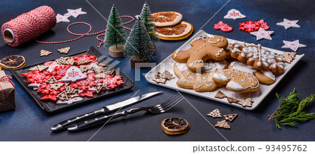Christmas decorations and gingerbreads on a dark concrete table. Getting ready to celebration 93495762