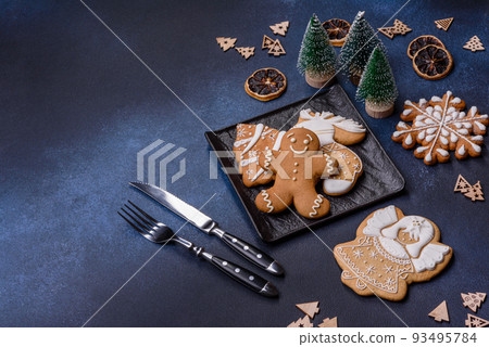 Christmas decorations and gingerbreads on a dark concrete table. Getting ready to celebration 93495784