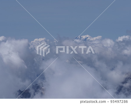 Foggy Mont Blanc peak above clouds seen from Switzerland Foggy Mont Blanc peak above clouds seen from Switzerland 93497286