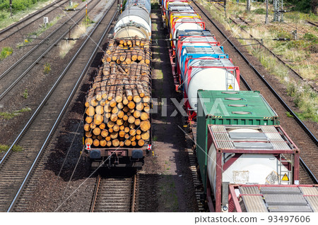 Above view of railway sorting station with many lines directions in Germany. Railroad car wooden timber logs and gas tanks logistics. Raw wood heating material transportation. Freight cargo transport 93497606