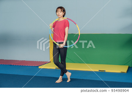 Woman doing hula hoop Woman doing hula hoop 93498904