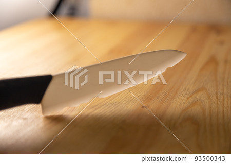 old broken ceramic knife on wooden table 93500343