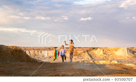 Teenagers run with a kite, outdoor activity on a day off 93500707