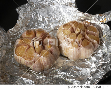 Two whole heads garlic right out of the oven. Golden roasted garlic cloves Two whole heads garlic right out of the oven. Golden roasted garlic cloves 93501192