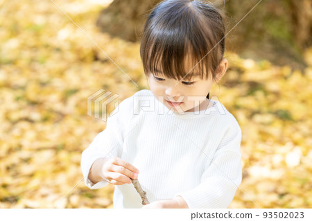 girl playing in autumn leaves girl playing in autumn leaves 93502023