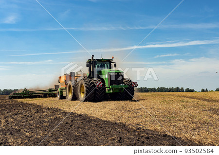 The tractor plows the land. Agriculture image. The tractor plows the land. Agriculture image. 93502584