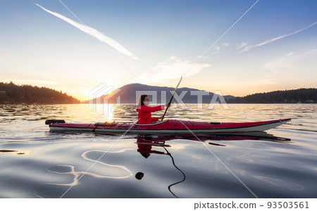 Adventurous Woman on Sea Kayak paddling in the Pacific Ocean. 93503561