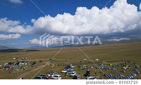 Big white clouds over green hills and mountains. 93503710