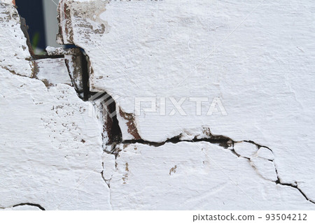 Stone wall with deep cracks. Break in the ground. Drought and consequences. Stone wall with deep cracks. Break in the ground. Drought and consequences. 93504212