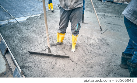 Contractors spread cement grout using trowel Contractors spread cement grout using trowel 93506048