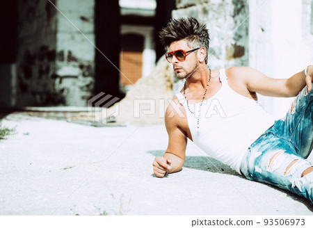 Portrait of handsome man in casual clothing posing in abandoned place, looking away to a side. Color Toned Image. Concept urban man. Portrait of handsome man in casual clothing posing in abandoned place, looking away to a side. Color Toned Image. Concept urban man. 93506973