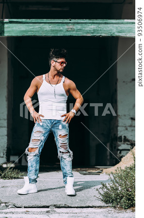 Portrait of handsome man in casual clothing posing in abandoned place, looking away to a side. Color Toned Image. Concept urban man. Portrait of handsome man in casual clothing posing in abandoned place, looking away to a side. Color Toned Image. Concept urban man. 93506974