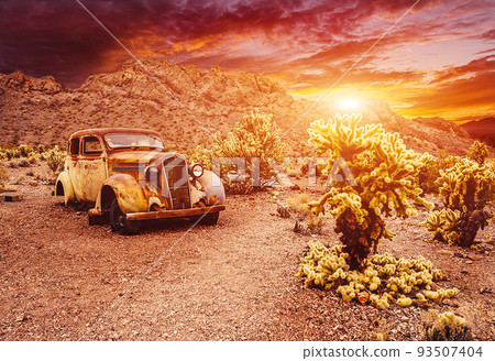Old vintage car truck abandoned in the desert at the sunset Old vintage car truck abandoned in the desert at the sunset 93507404