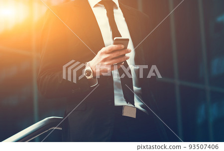 Success business man using cell phone. Concept businessman lifestyle. Toned Image. Success business man using cell phone. Concept businessman lifestyle. Toned Image. 93507406