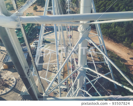 Ferris wheel. a robust, metal, white construction for lifting people and booths into the air to survey the city. amusement park 93507824