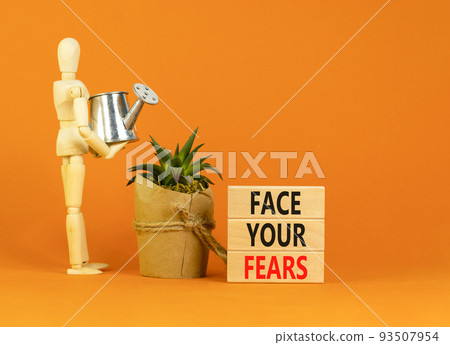 Face your fears and support symbol. Concept words Face your fears on wooden blocks. Businessman model. Beautiful orange table orange background. Business and Face your fears quote concept. Copy space. 93507954