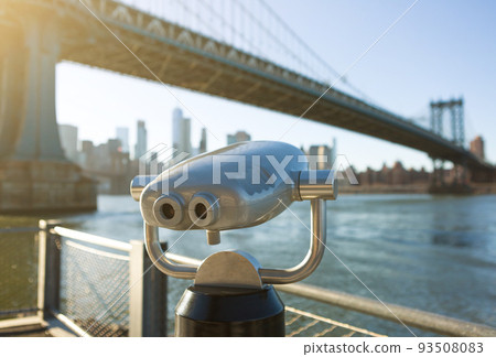 View of Manhattan bridge and New York City with a coin operated telescope binoculars viewer for tourists. 93508083