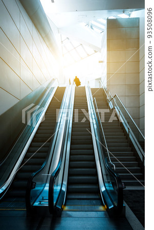 Silhouette of a unrecognizable business travelers people at international airport moving to terminal gate for airplane travel trip Silhouette of a unrecognizable business travelers people at international airport moving to terminal gate for airplane travel trip 93508096