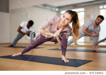 People exercising asana in gym 93510862