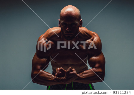 Brutal strong athletic bodybuilding men posing in studio. Bodybuilding and healty life concept  93511284