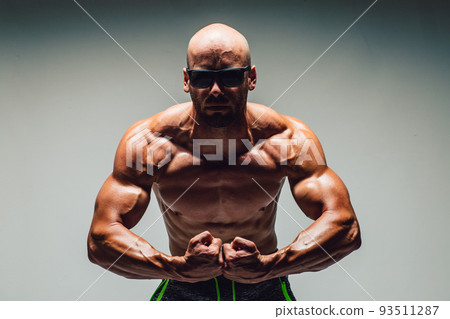 Brutal strong athletic bodybuilding men posing in studio. Bodybuilding and healty life concept Brutal strong athletic bodybuilding men posing in studio. Bodybuilding and healty life concept 93511287