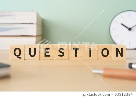 Image of a question | Desk with a block written "QUESTION" 93512384