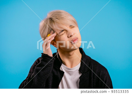 Asian man having headache, studio portrait. Korean stylish guy putting hands on head, isolated on Asian man having headache, studio portrait. Korean stylish guy putting hands on head, isolated on 93513335